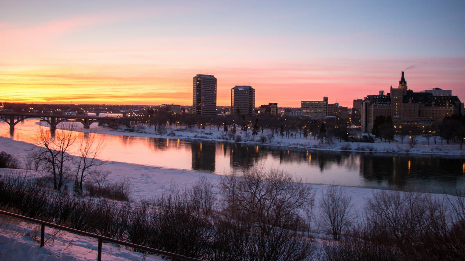Saskatoon skyline and river at sunset on a snowy winter evening