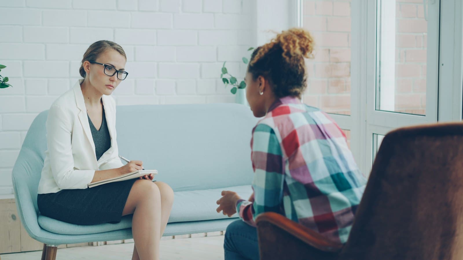 Therapist listening to a client during a calm counselling session