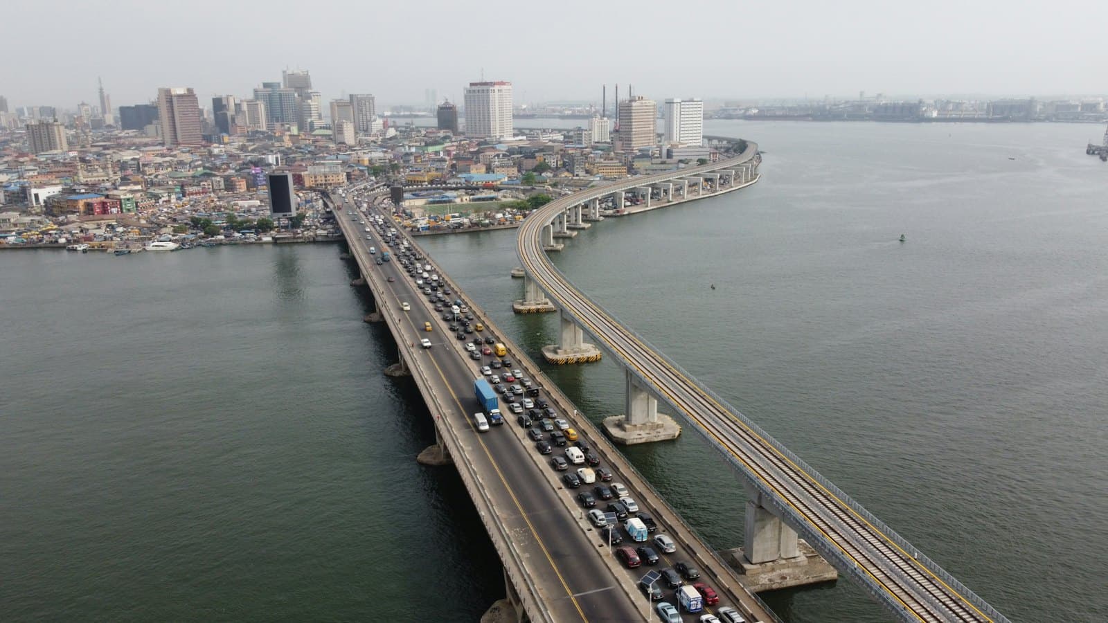 Aerial view of traffic on a bridge into Lagos Island with the city skyline ahead