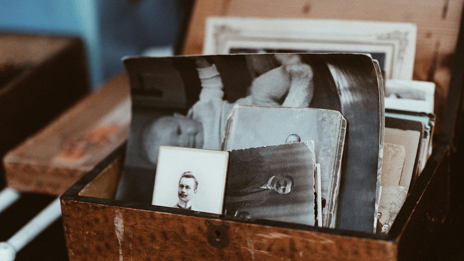 Old family photographs and papers stored in a wooden chest