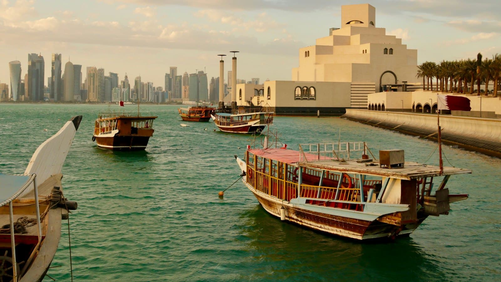 Traditional dhow boats on the water near the Museum of Islamic Art in Doha