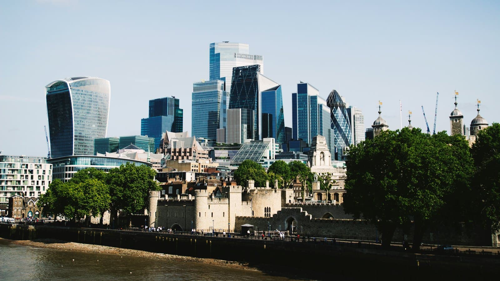 City of London office towers rising behind the Tower of London and the Thames