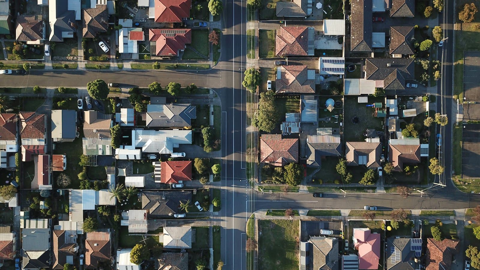 Aerial view of a suburban neighbourhood with rows of houses and streets