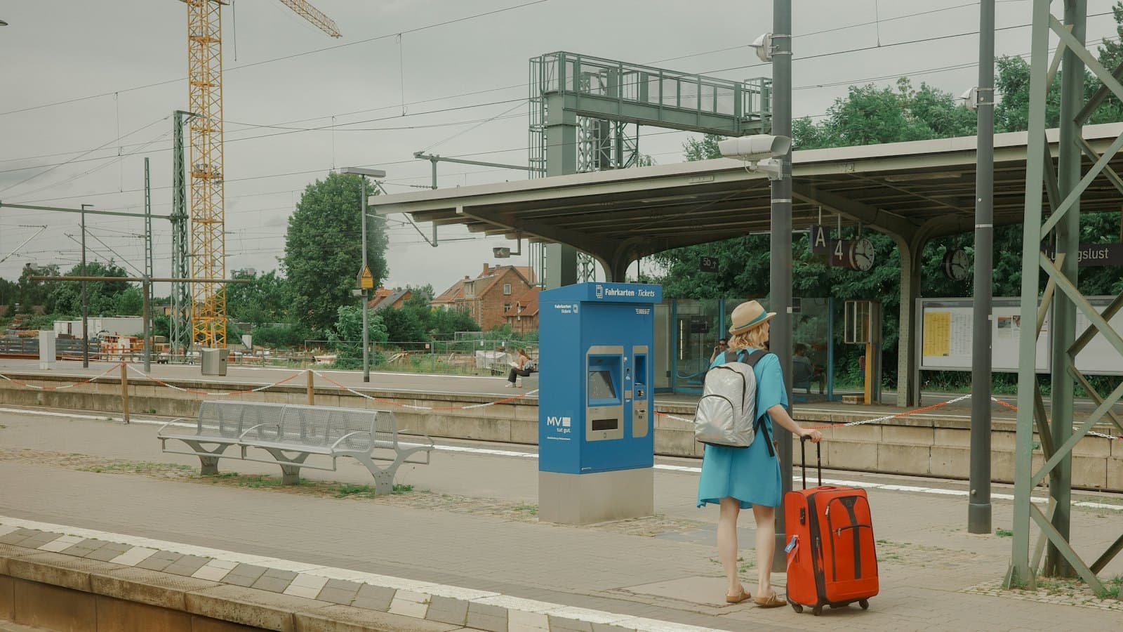 Woman with a suitcase waiting on a train station platform