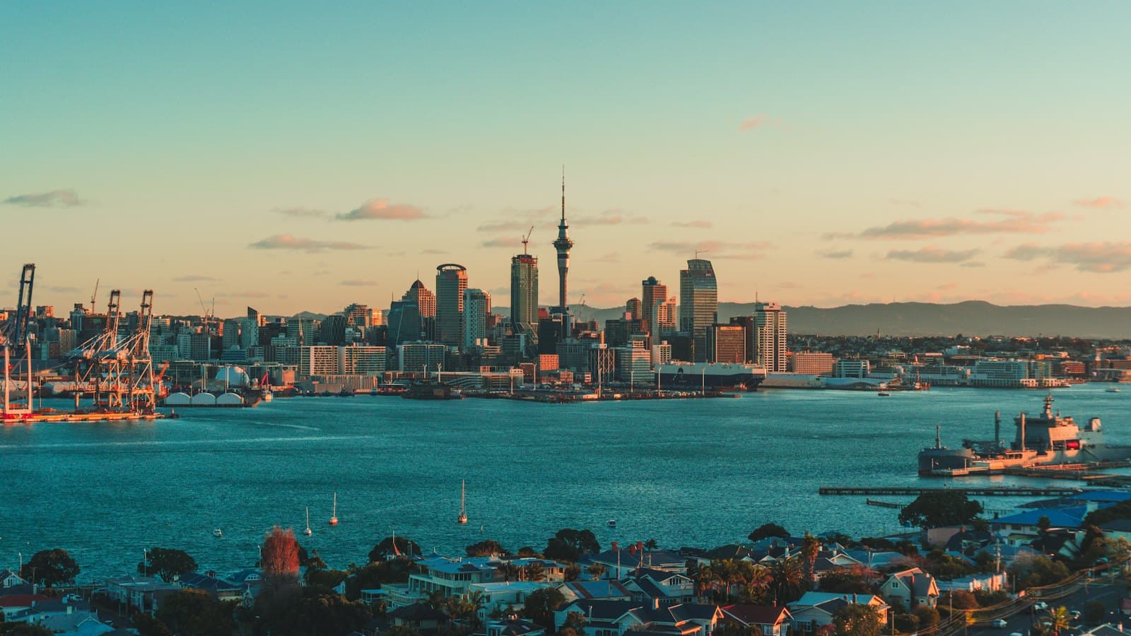 The Auckland skyline and harbour under a warm low sun