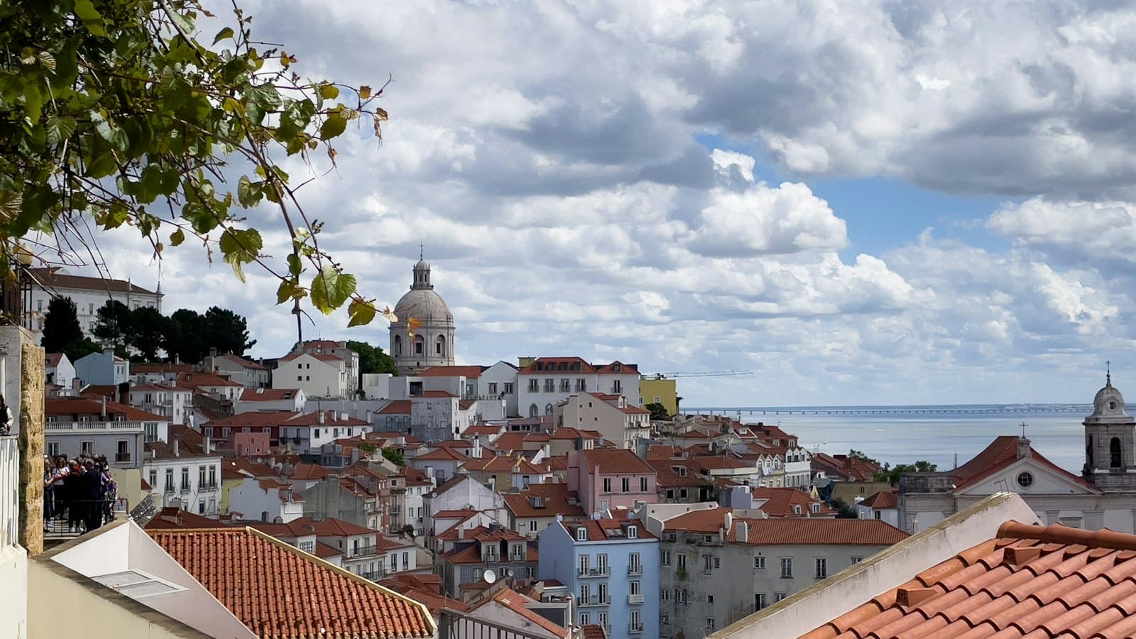 Lisbon cityscape with terracotta tiled roofs stretching toward the water