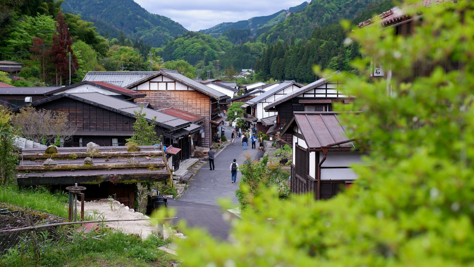A traditional Japanese village nestled in a green mountain valley