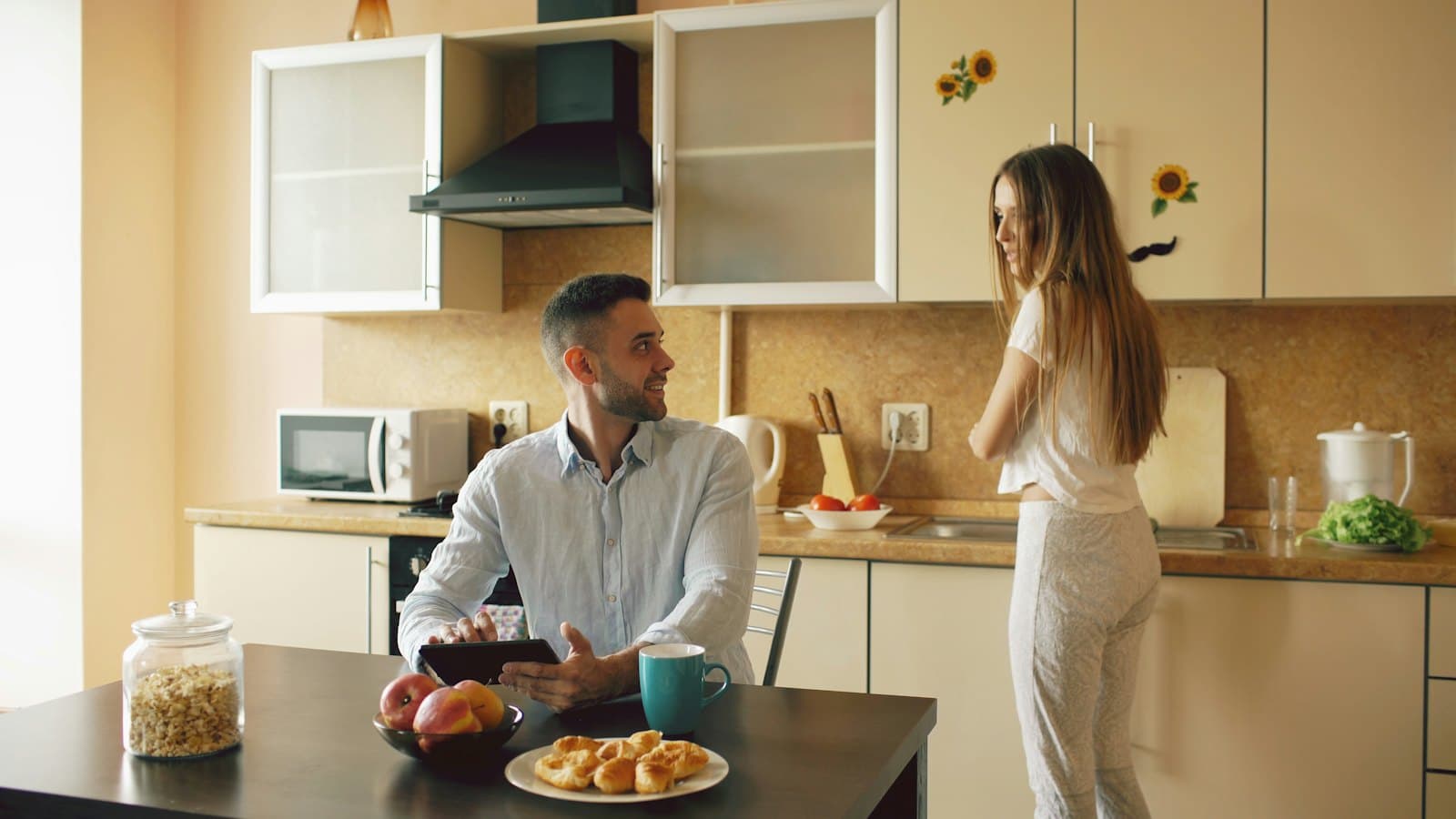 Couple chatting in their kitchen over breakfast